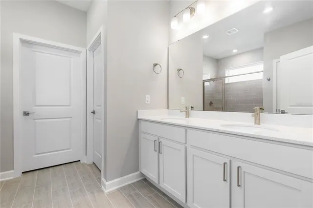 a bathroom with a double vanity sink and a mirror