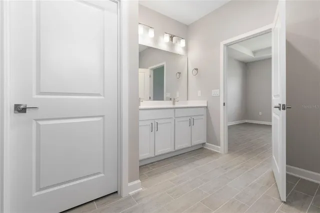 a view of a bathroom with mirror and sink