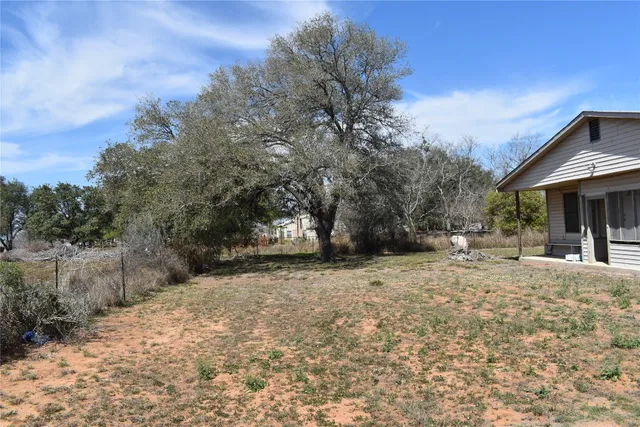 a view of a house with a tree in the background