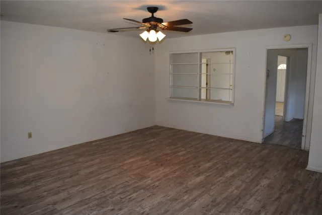 wooden floor in an empty room with a window