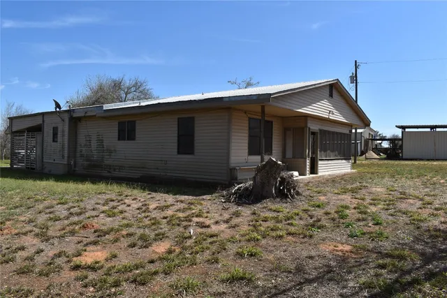 a backyard of a house with table and chair