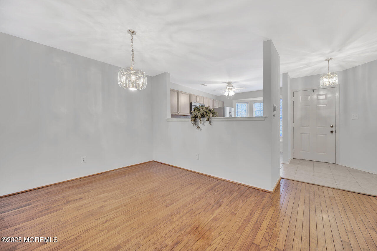 Undisclosed Address Holmdel, NJ 07733 - Photo 12 of 28 a view of a room with wooden floor and windows