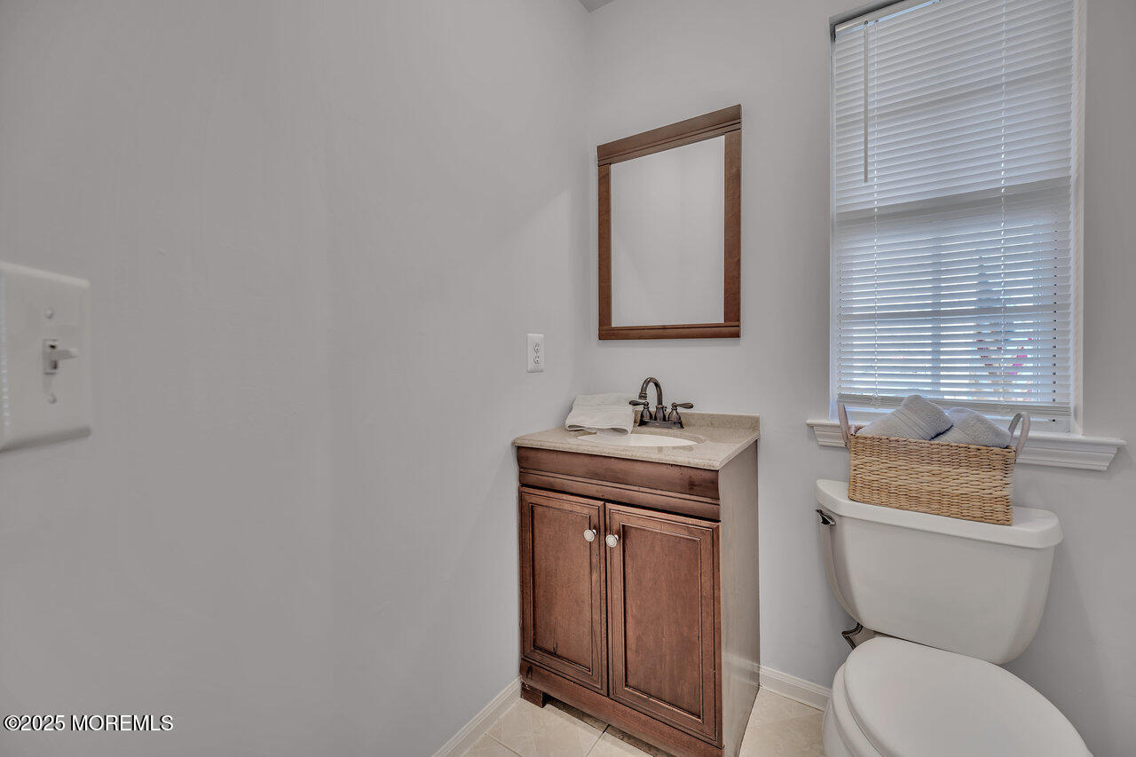 Undisclosed Address Holmdel, NJ 07733 - Photo 14 of 28 a bathroom with a toilet a sink and mirror