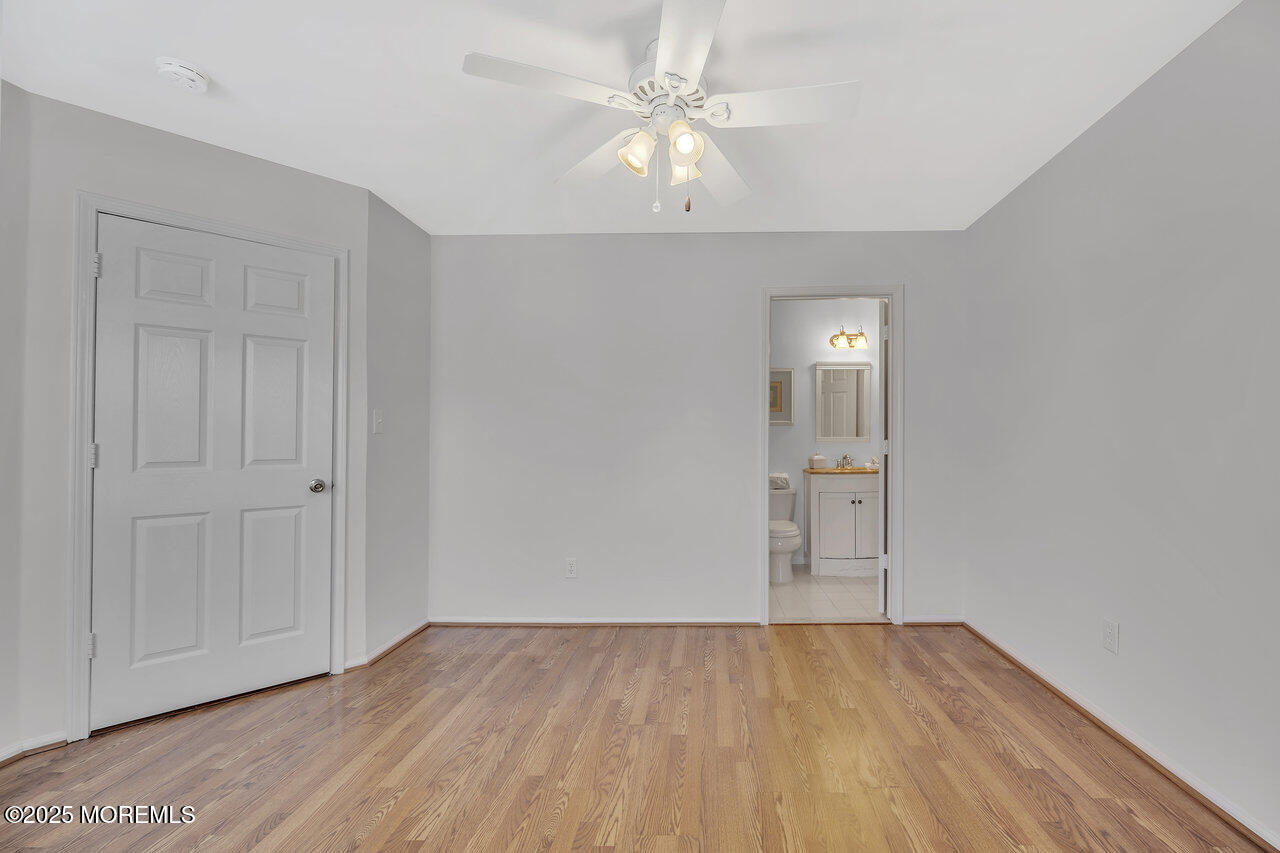 Undisclosed Address Holmdel, NJ 07733 - Photo 18 of 28 wooden floor in an empty room with a window