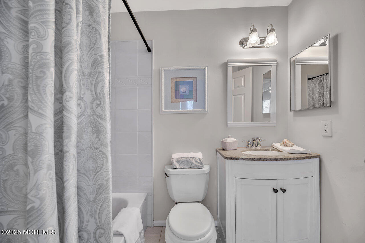 Undisclosed Address Holmdel, NJ 07733 - Photo 19 of 28 a bathroom with a toilet sink and mirror