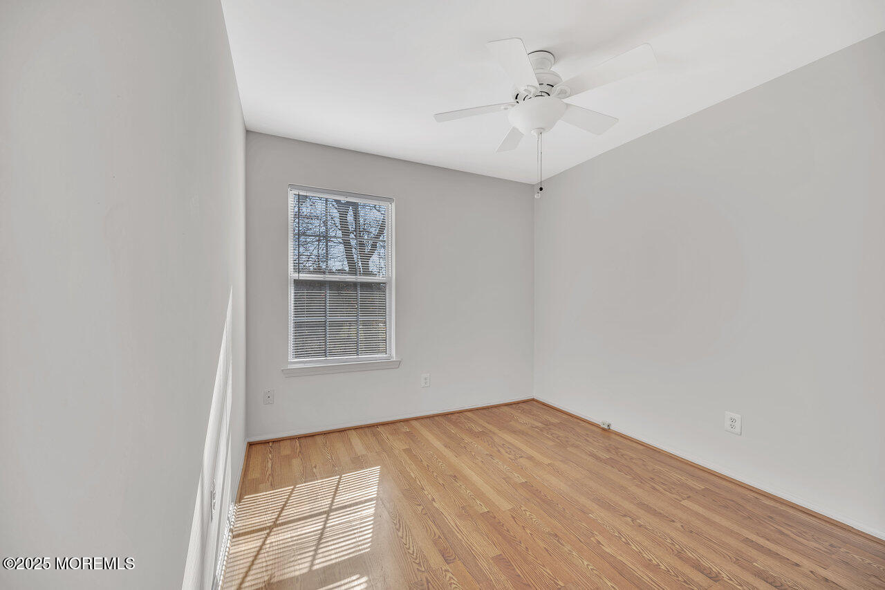 Undisclosed Address Holmdel, NJ 07733 - Photo 21 of 28 an empty room with a window and a ceiling fan