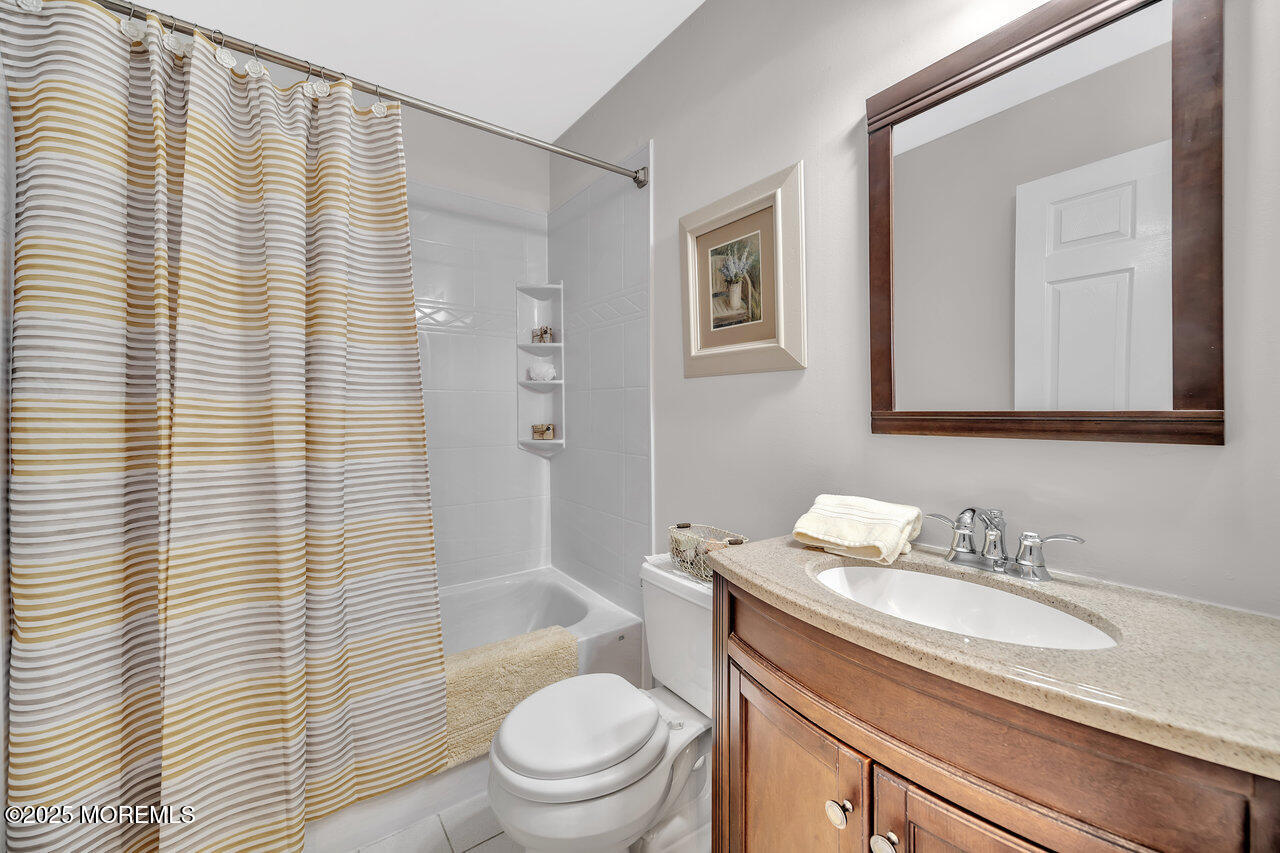 Undisclosed Address Holmdel, NJ 07733 - Photo 26 of 28 a bathroom with a sink a toilet and shower