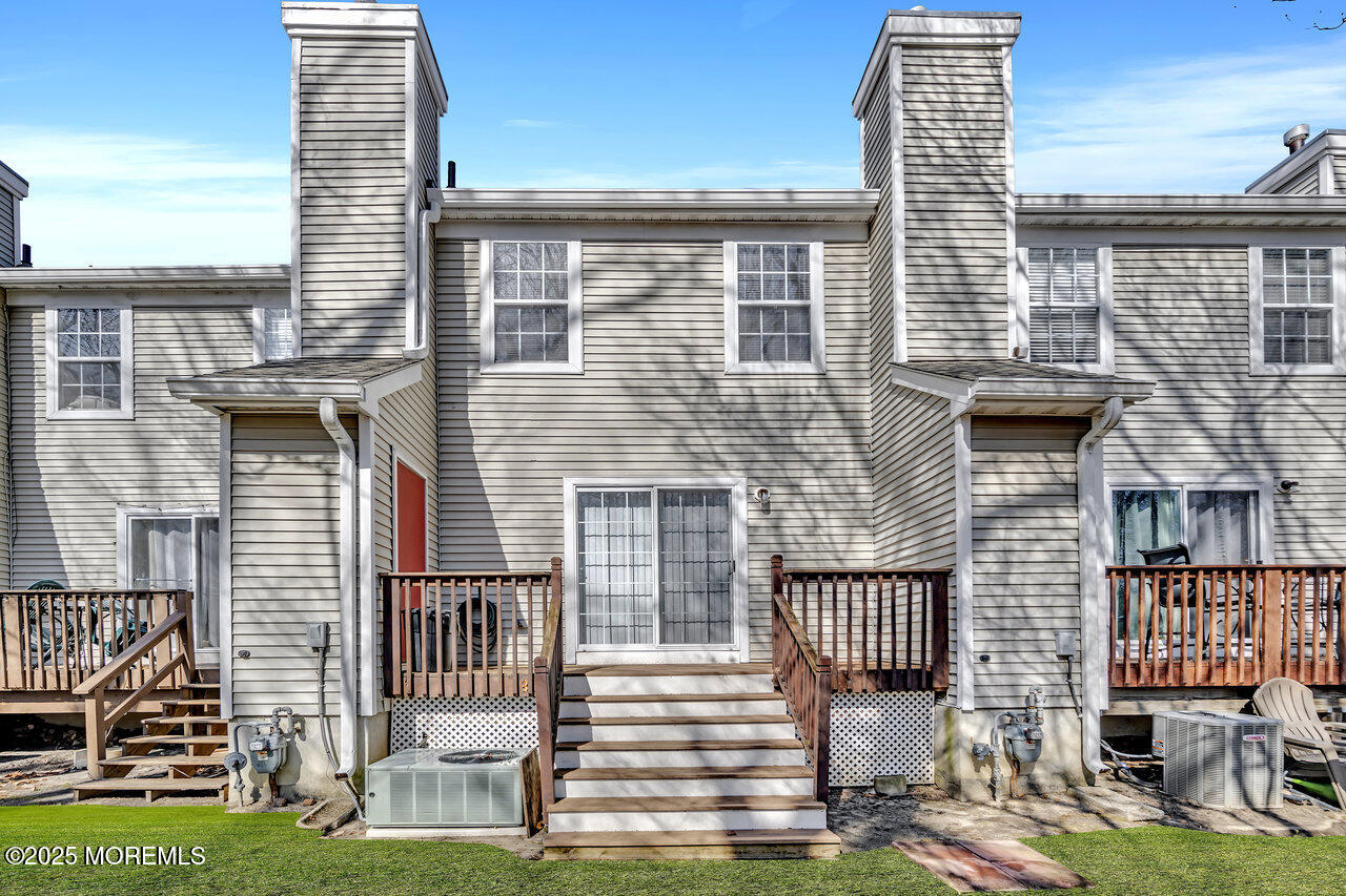 Undisclosed Address Holmdel, NJ 07733 - Photo 3 of 28 a front view of a house with a garden