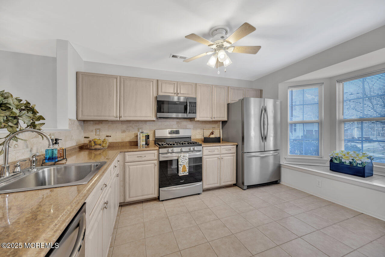Undisclosed Address Holmdel, NJ 07733 - Photo 6 of 28 a kitchen with refrigerator a sink and a stove