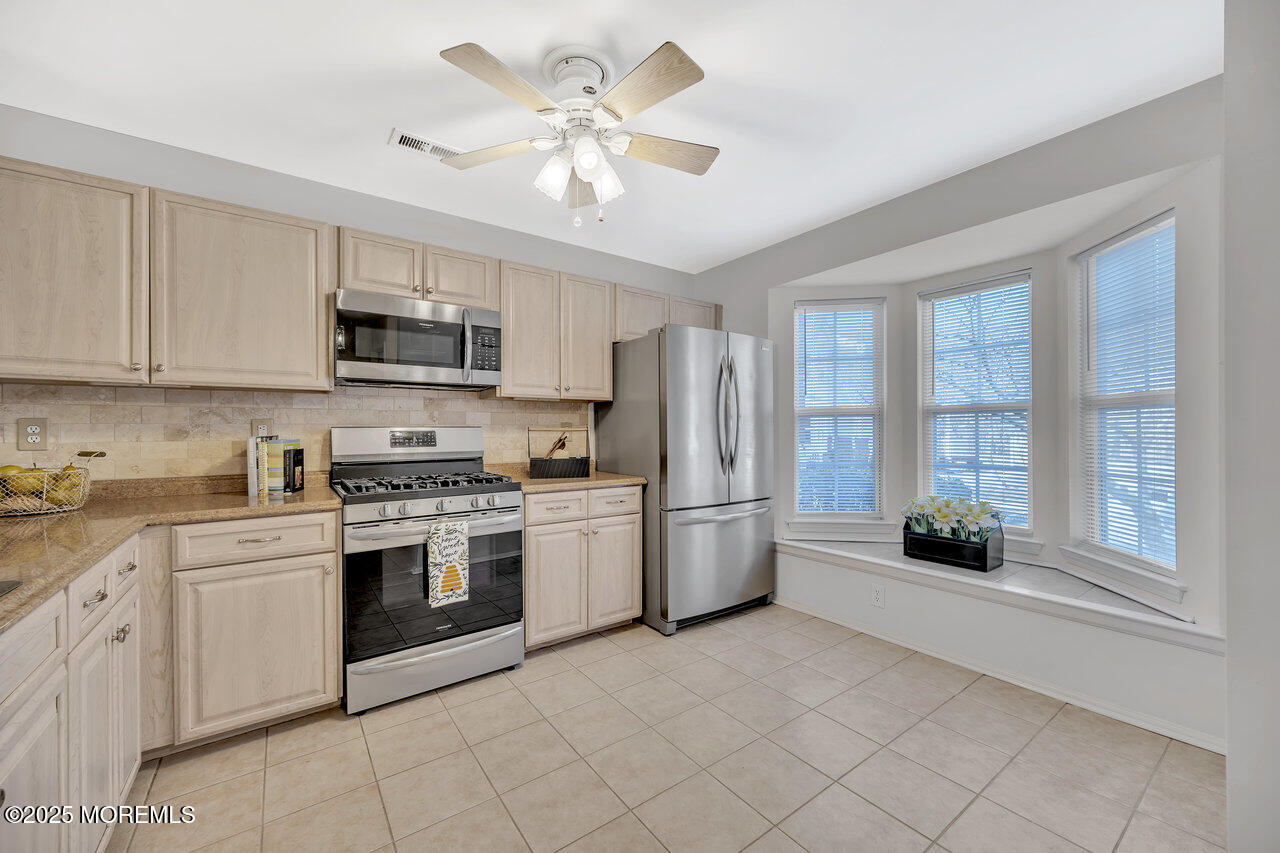 Undisclosed Address Holmdel, NJ 07733 - Photo 8 of 28 a kitchen with a stove a refrigerator and a sink