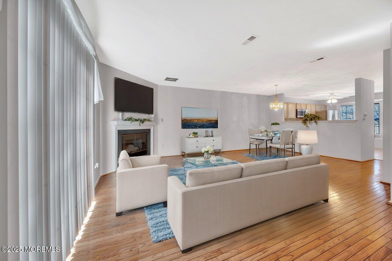 Undisclosed Address Holmdel, NJ 07733 - Photo 10 of 28 a living room with furniture a flat screen tv and a fireplace