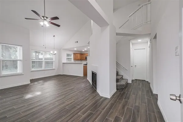 a view of a kitchen with wooden floor and a ceiling fan