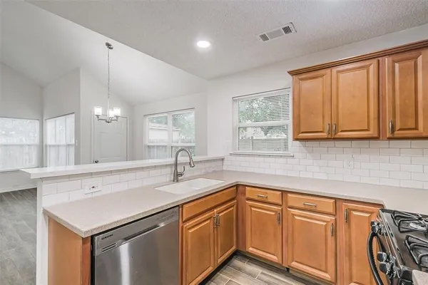 a kitchen with a sink cabinets and window