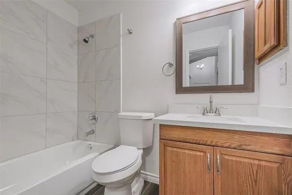 a bathroom with a sink toilet vanity and tub