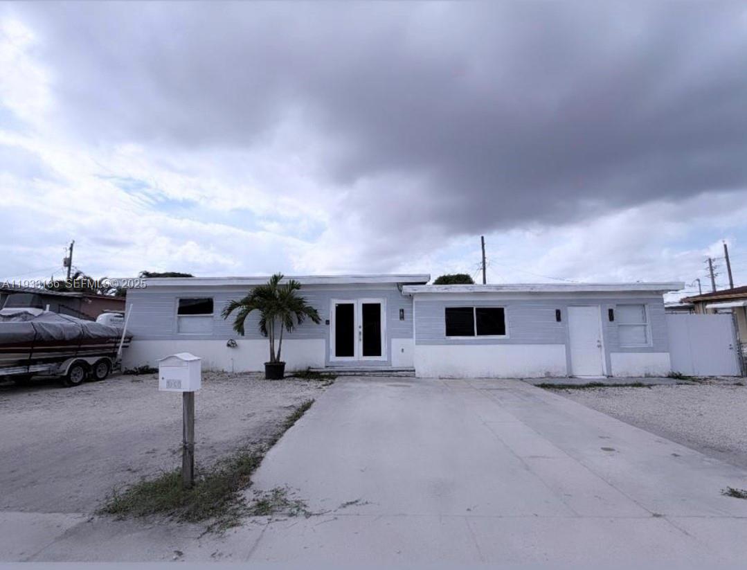 5168 East 8th Lane Hialeah, FL 33013 - Photo 1 of 19 a big house with a yard and parking space