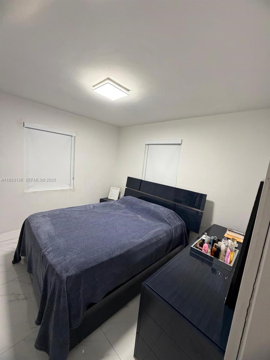 5168 East 8th Lane Hialeah, FL 33013 - Photo 12 of 19 a bedroom with a bed and a dresser