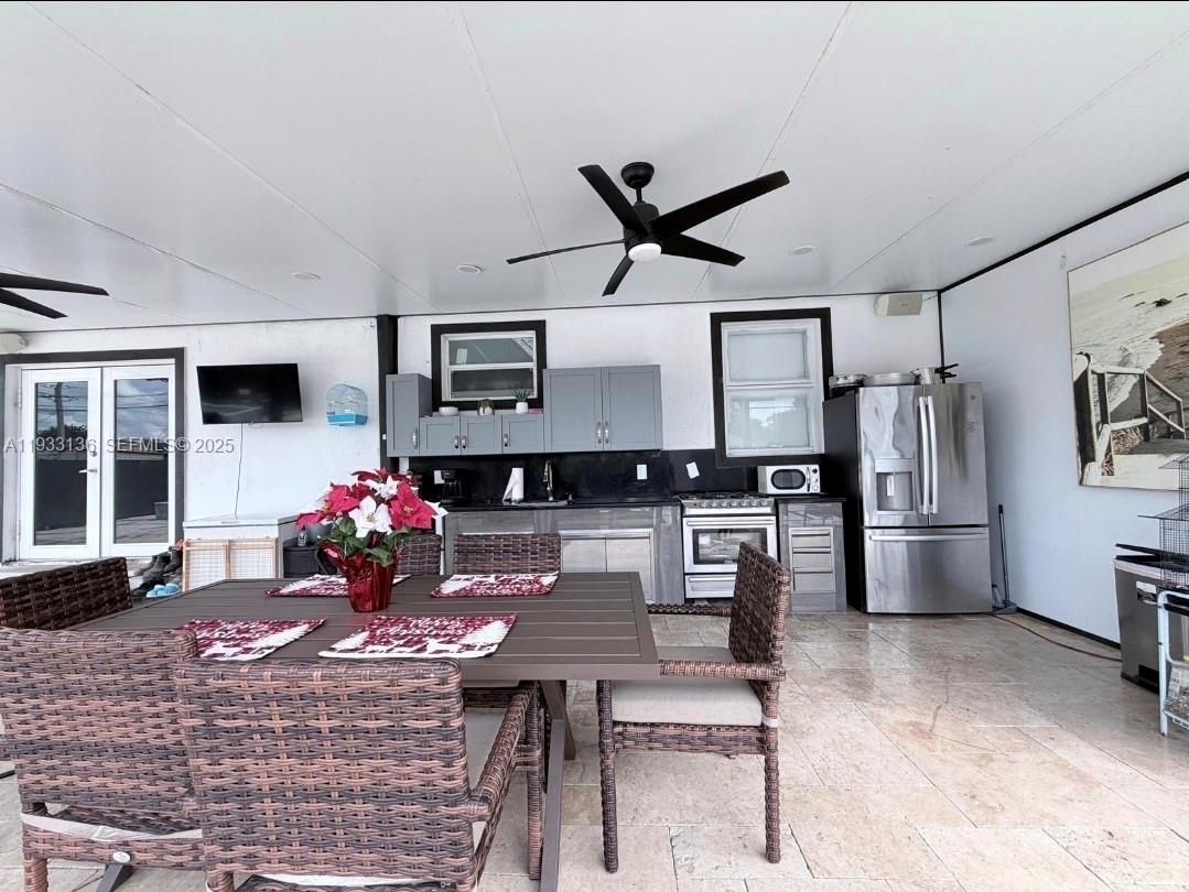 5168 East 8th Lane Hialeah, FL 33013 - Photo 19 of 19 a living room with furniture and kitchen view