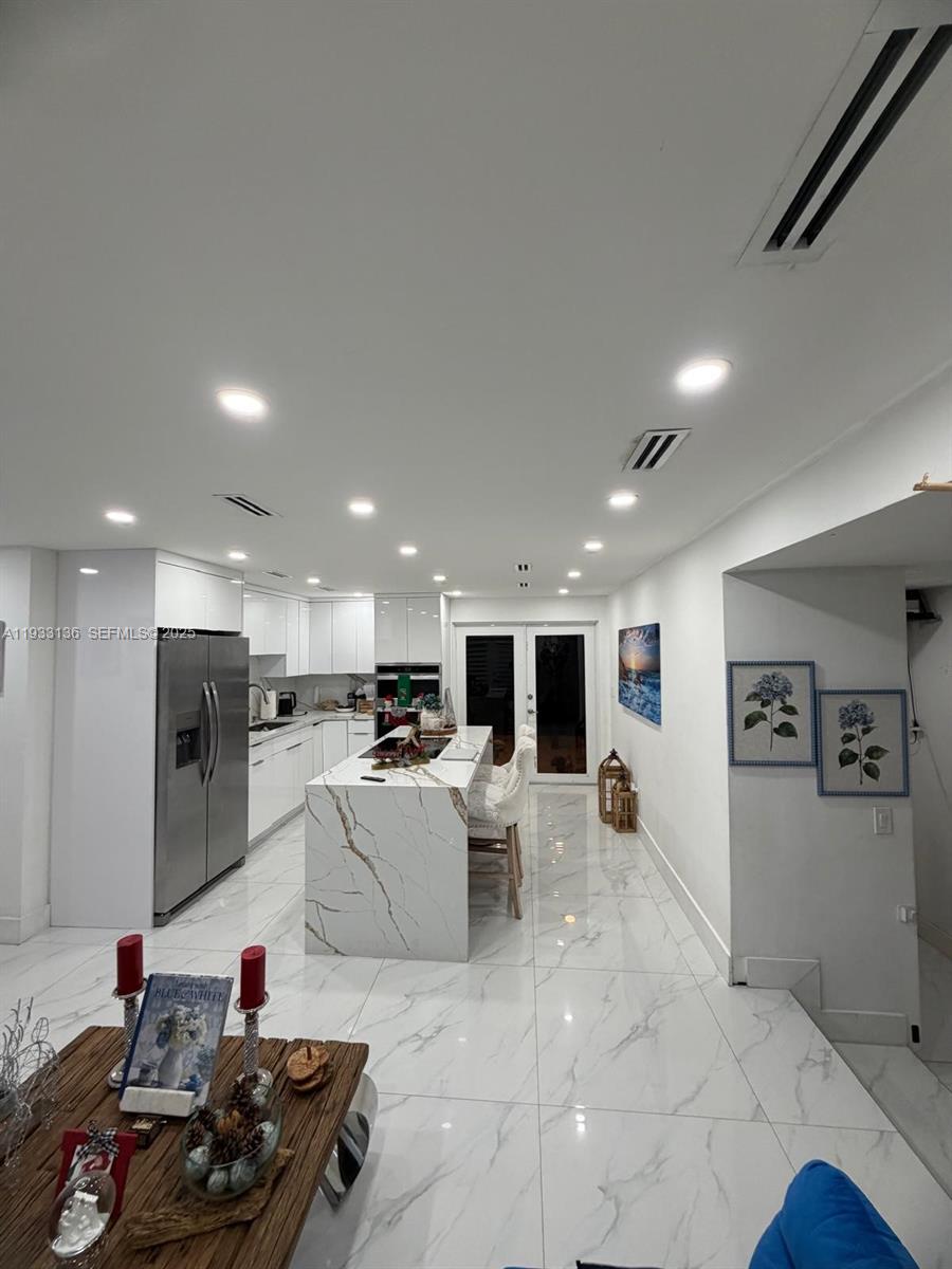 5168 East 8th Lane Hialeah, FL 33013 - Photo 4 of 19 a large white kitchen with lots of counter space