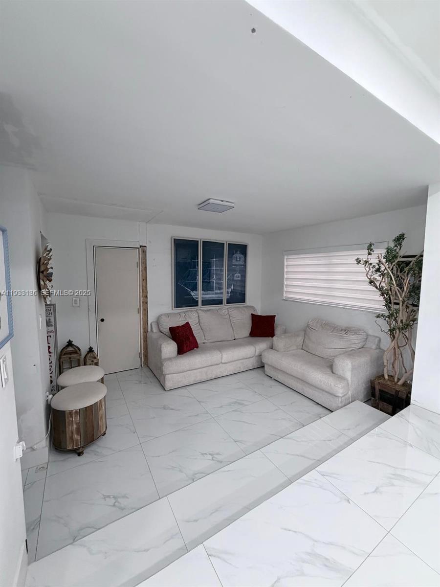 5168 East 8th Lane Hialeah, FL 33013 - Photo 6 of 19 a living room with furniture and a potted plant