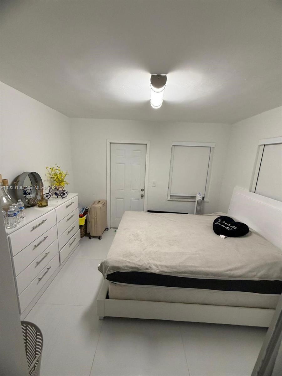 5168 East 8th Lane Hialeah, FL 33013 - Photo 9 of 19 a bedroom with a bed and a dresser