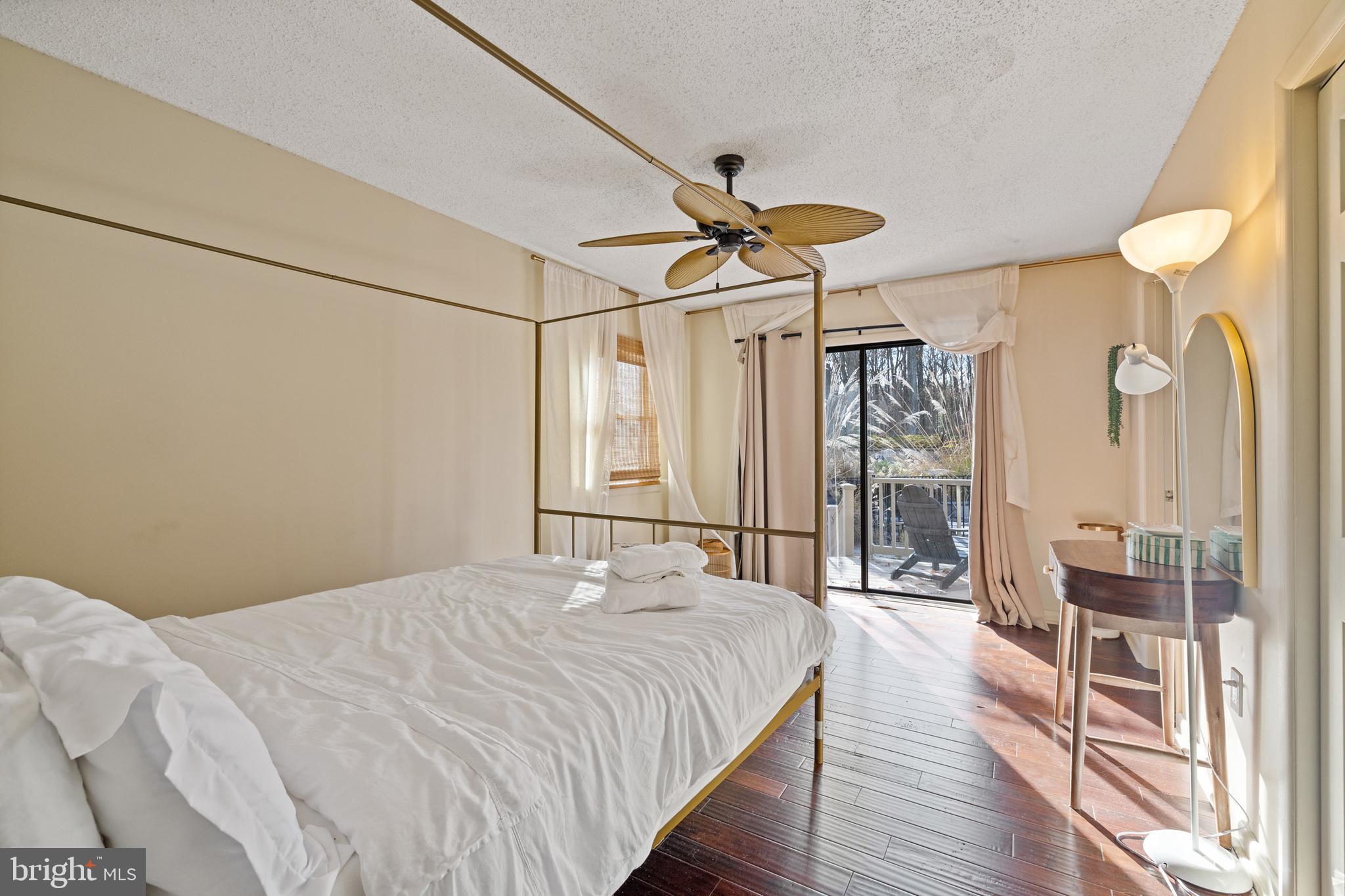 109 Woodmoor Road Stevensville, MD 21666 - Photo 25 of 31 a bedroom with a bed and a chandelier