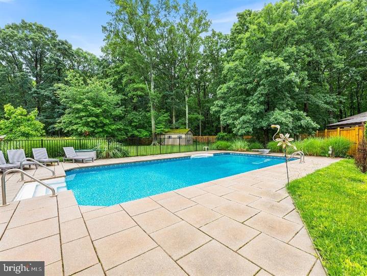 109 Woodmoor Road Stevensville, MD 21666 - Photo 8 of 31 a view of pool with lawn chairs and large trees
