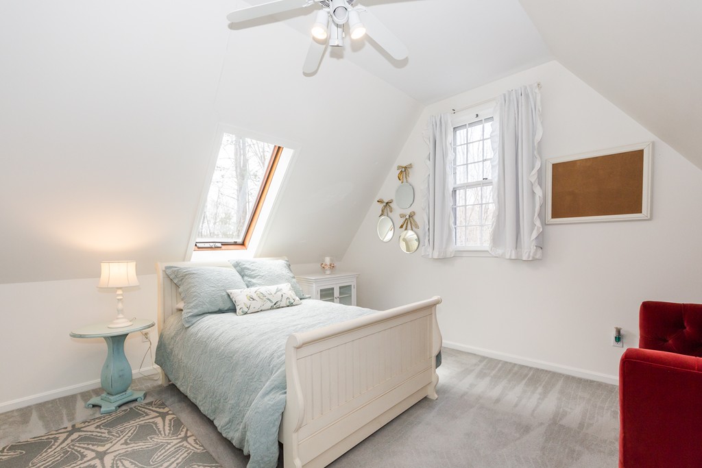 7 Buttonwood Road Amesbury, MA 01913 - Photo 21 of 29 a bedroom with a bed and a chandelier