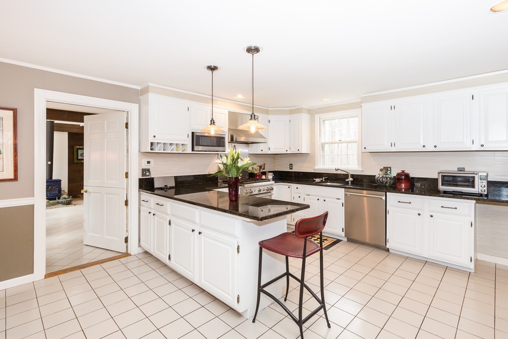 7 Buttonwood Road Amesbury, MA 01913 - Photo 3 of 29 a kitchen with stainless steel appliances granite countertop a sink and cabinets