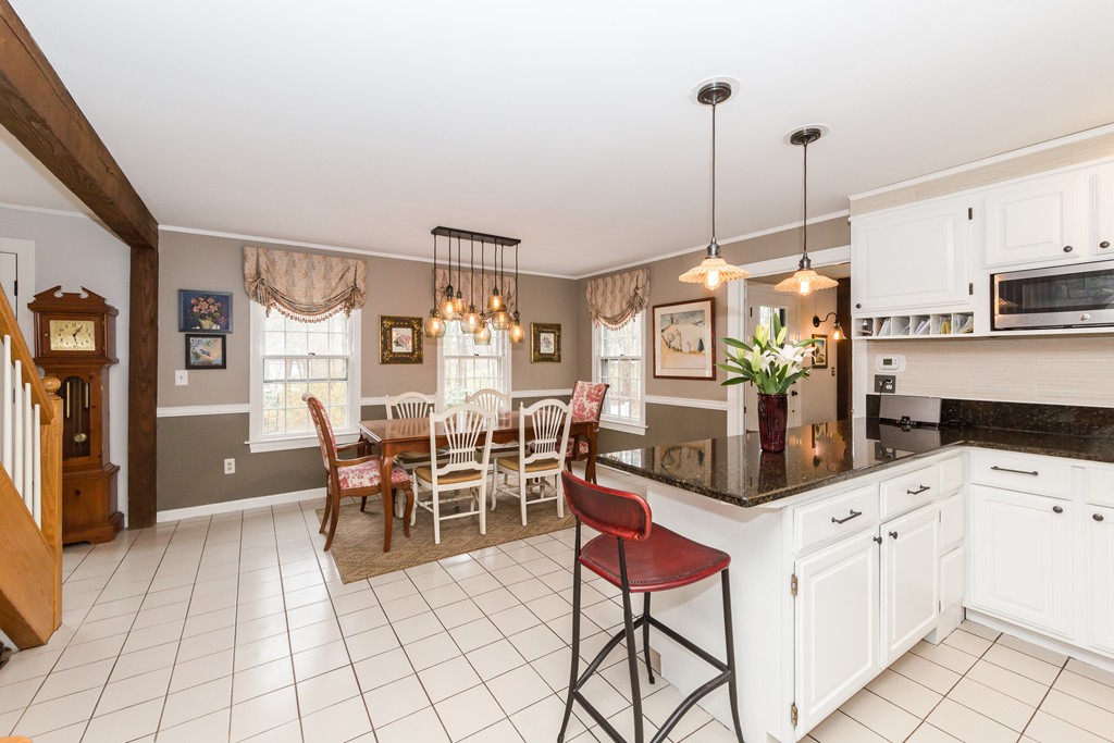7 Buttonwood Road Amesbury, MA 01913 - Photo 7 of 29 a kitchen with granite countertop cabinets and chairs