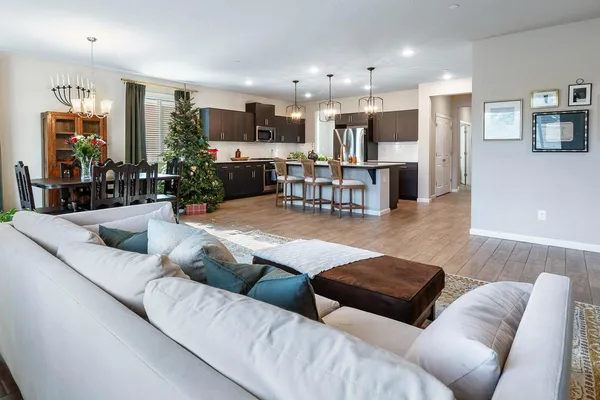 a living room with furniture and kitchen view