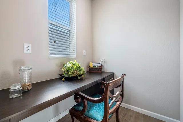 a room with chair and flower pot