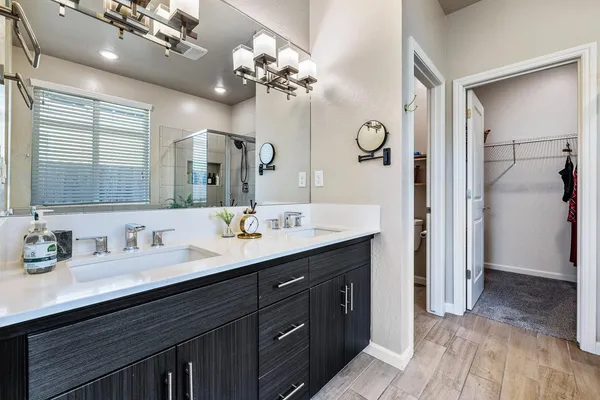 a bathroom with a double vanity sink and a mirror