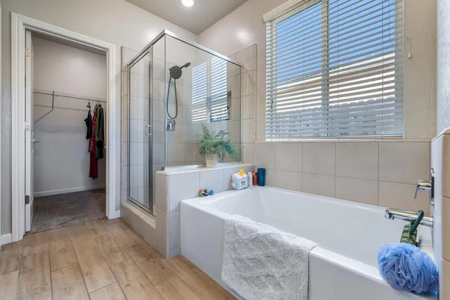 a bathroom with a tub a sink and a shower