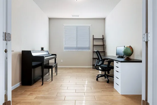 a view of a workspace with furniture and a window