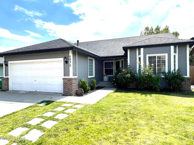 a view of a house with pool and garden