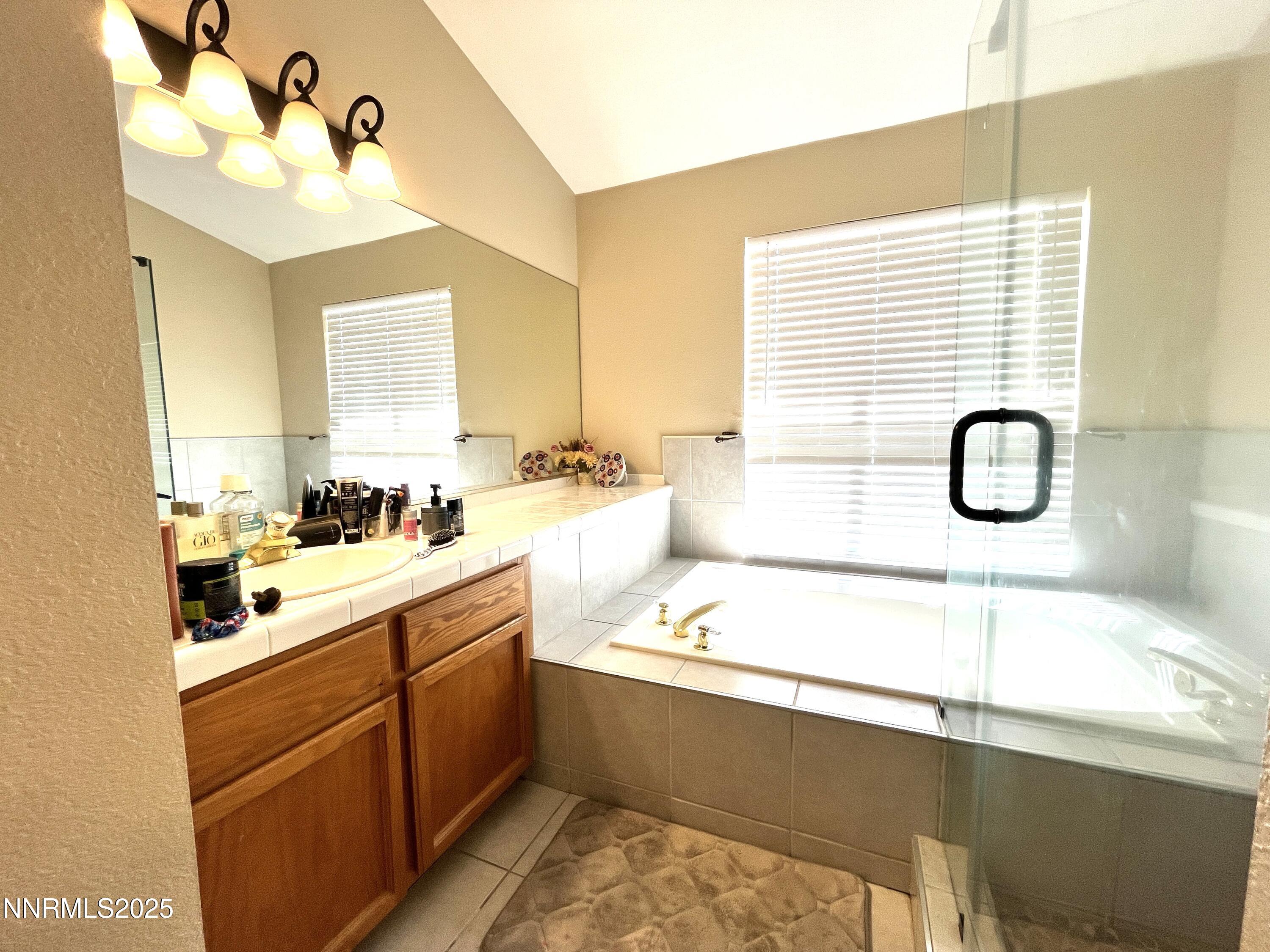 5870 Blue Horizon Drive Reno, NV 89523 - Photo 13 of 21 a bathroom with a double vanity sink and mirror