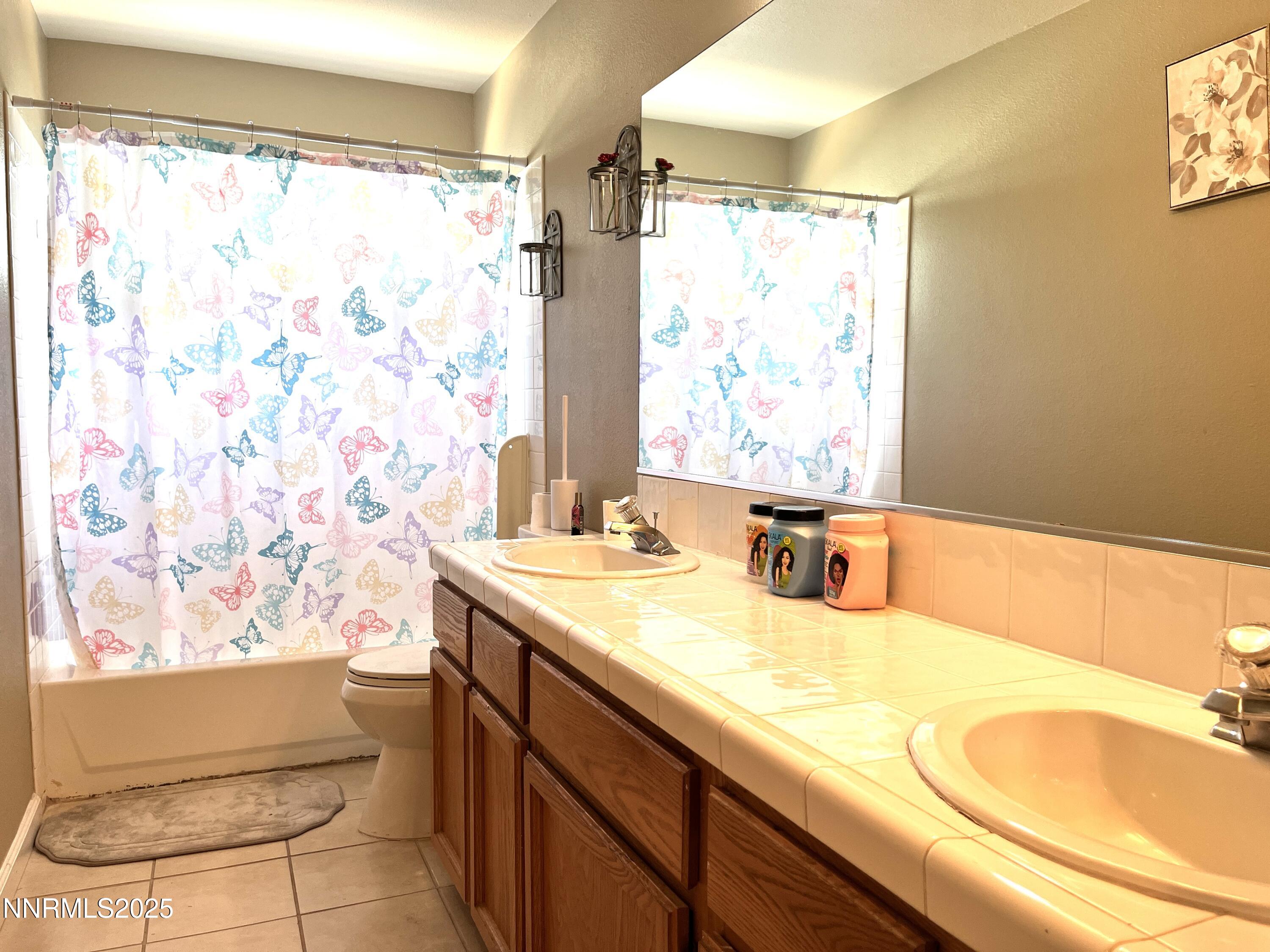 5870 Blue Horizon Drive Reno, NV 89523 - Photo 16 of 21 a bathroom with a granite countertop sink a mirror and a shower