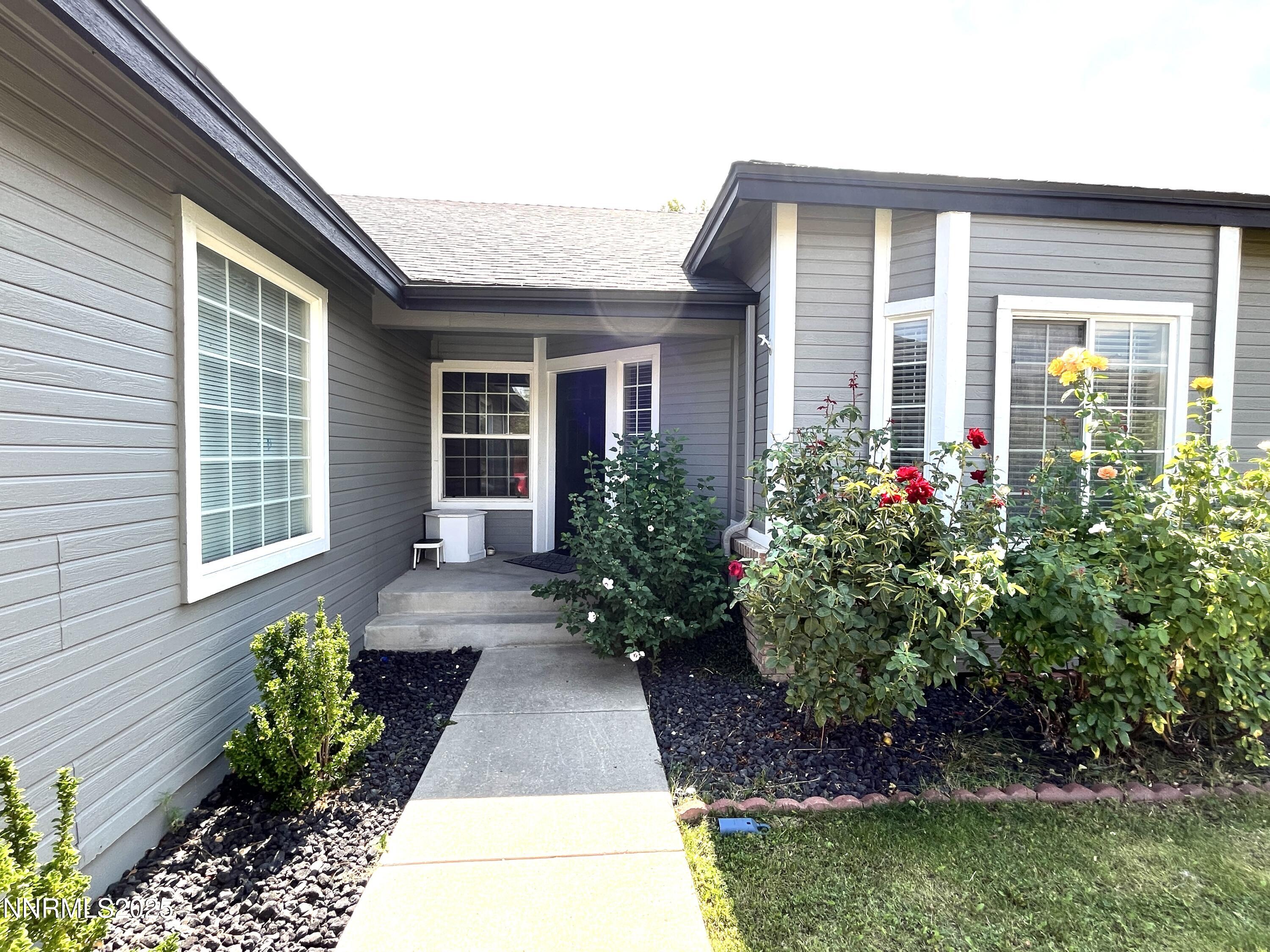 5870 Blue Horizon Drive Reno, NV 89523 - Photo 4 of 21 a front view of a house with garden
