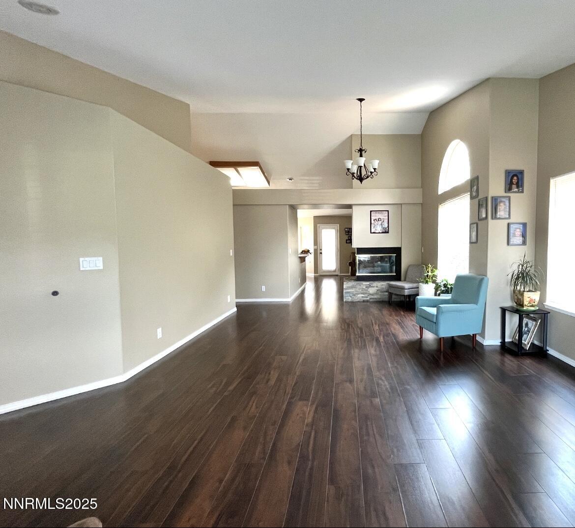5870 Blue Horizon Drive Reno, NV 89523 - Photo 5 of 21 a living room with couches bookshelf and a stove with wooden floor