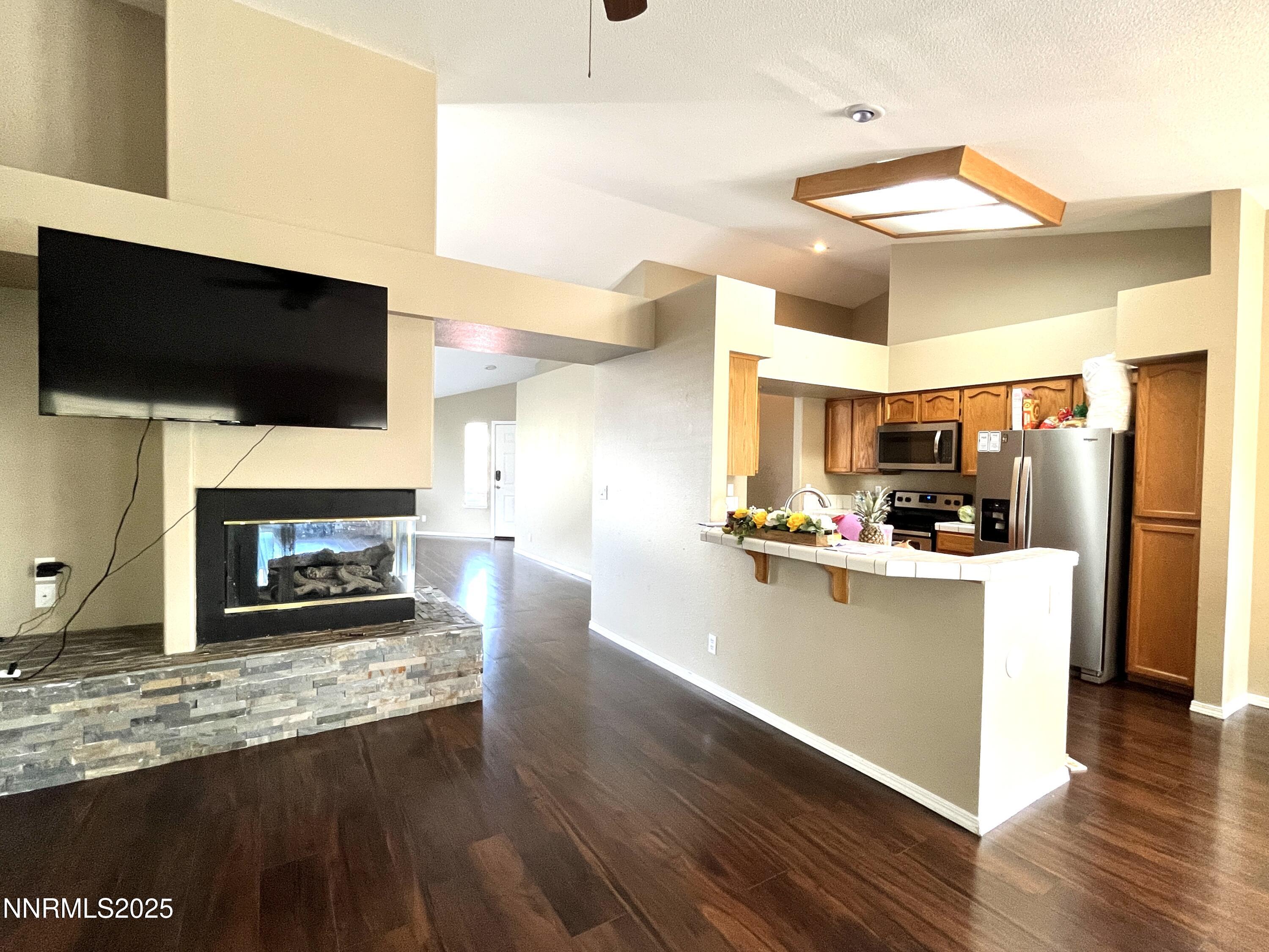5870 Blue Horizon Drive Reno, NV 89523 - Photo 10 of 21 a living room with furniture a flat screen tv and a fireplace