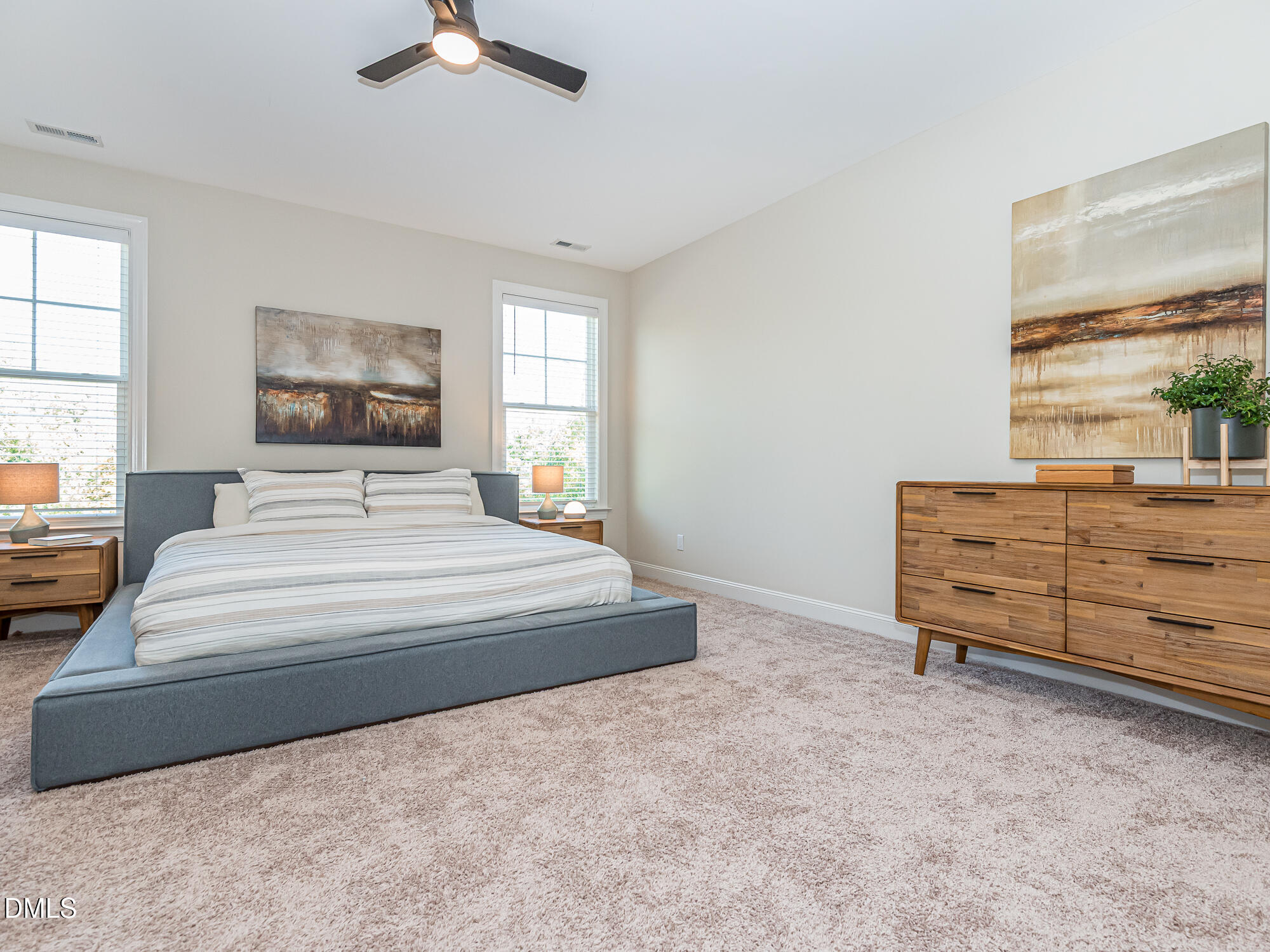 904 Dalton Ridge Place Apex, NC 27523 - Photo 10 of 36 a bedroom with a bed and a chandelier