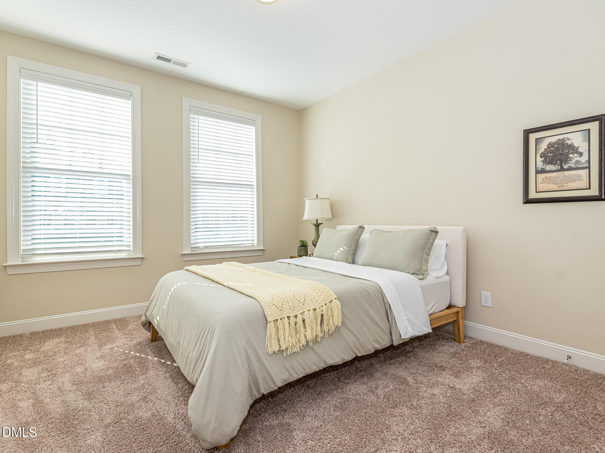 904 Dalton Ridge Place Apex, NC 27523 - Photo 16 of 36 a bed sitting in a bedroom next to a window