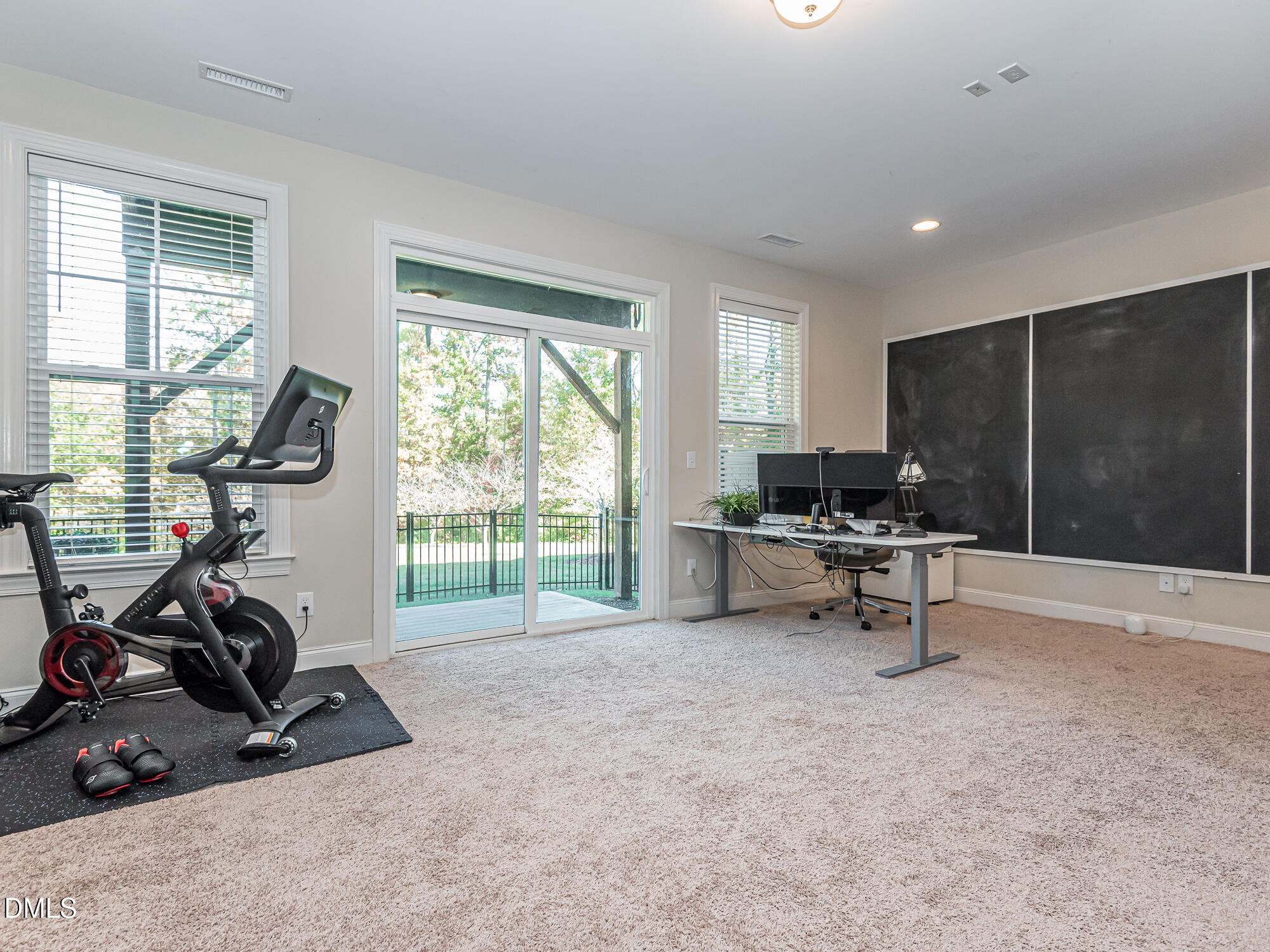 904 Dalton Ridge Place Apex, NC 27523 - Photo 19 of 36 a view of a room with gym equipment and a large window