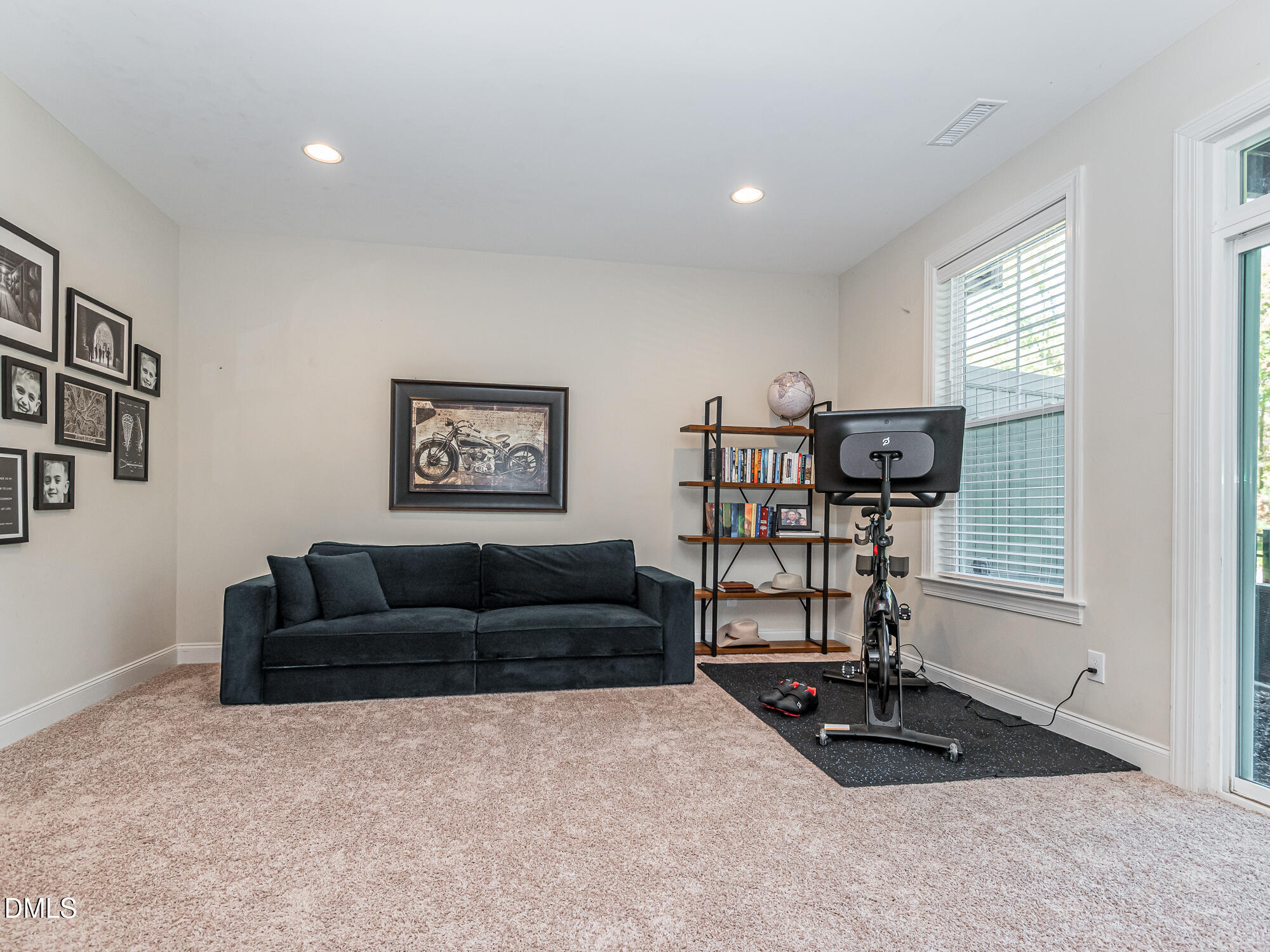 904 Dalton Ridge Place Apex, NC 27523 - Photo 21 of 36 a living room with furniture a window and gym equipment