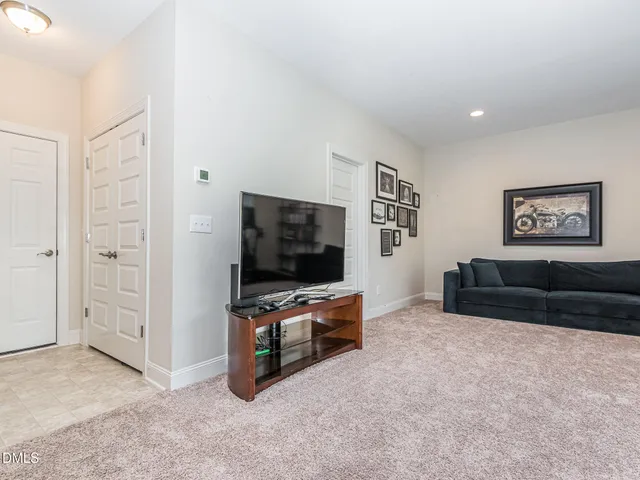 a living room with furniture a window and gym equipment