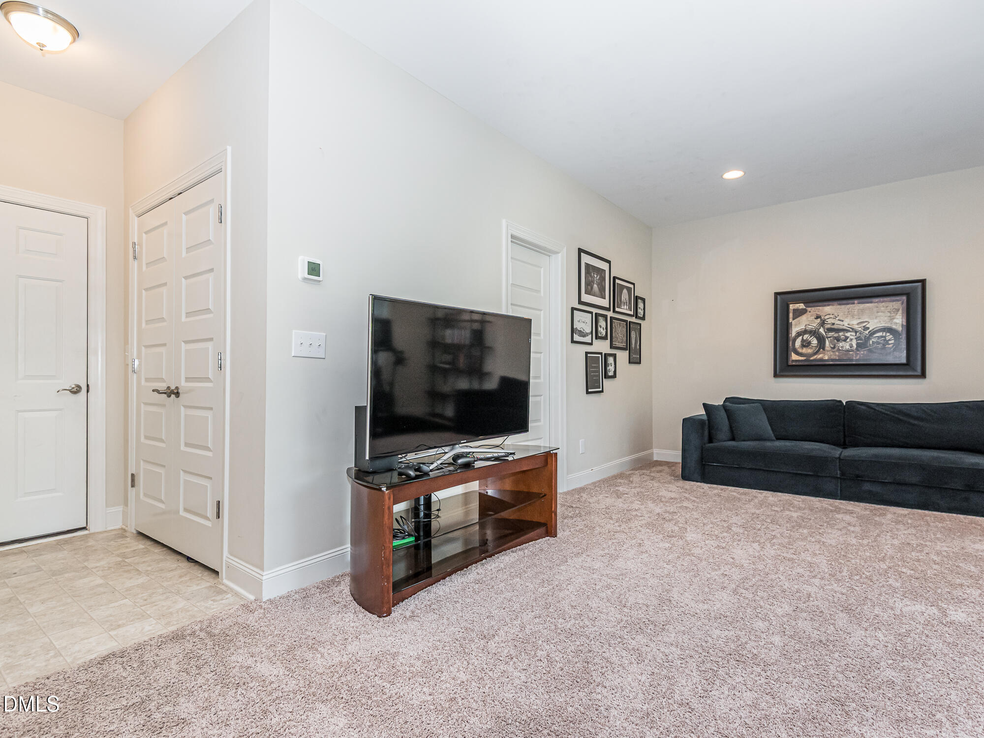 904 Dalton Ridge Place Apex, NC 27523 - Photo 22 of 36 a living room with furniture and a flat screen tv