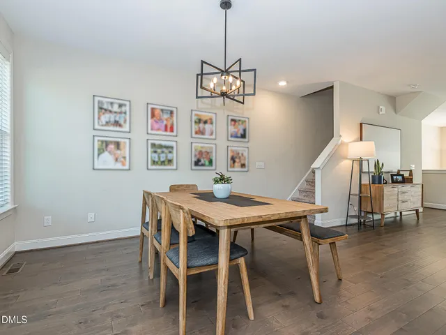a dining room with furniture window and wooden floor