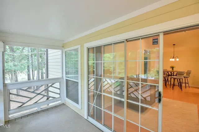 a view of a room with gym equipment and large windows