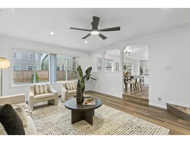 a living room with furniture and a potted plant