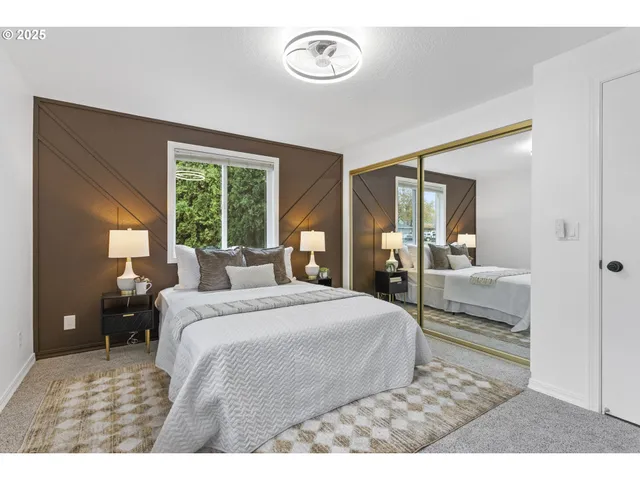 a bedroom with a large bed and a chandelier